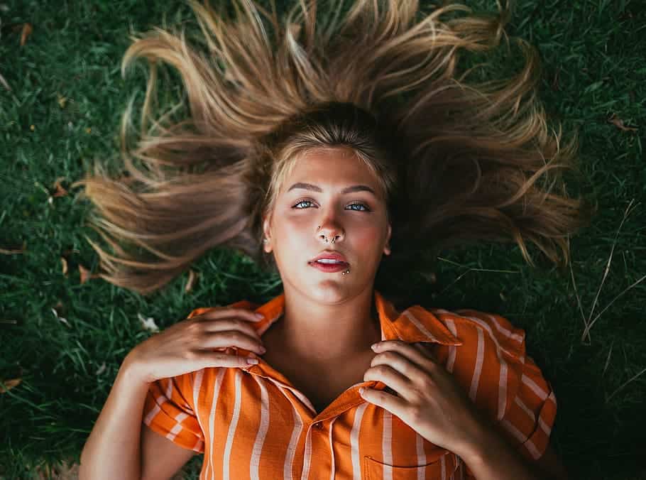 photo of a woman lying on ground