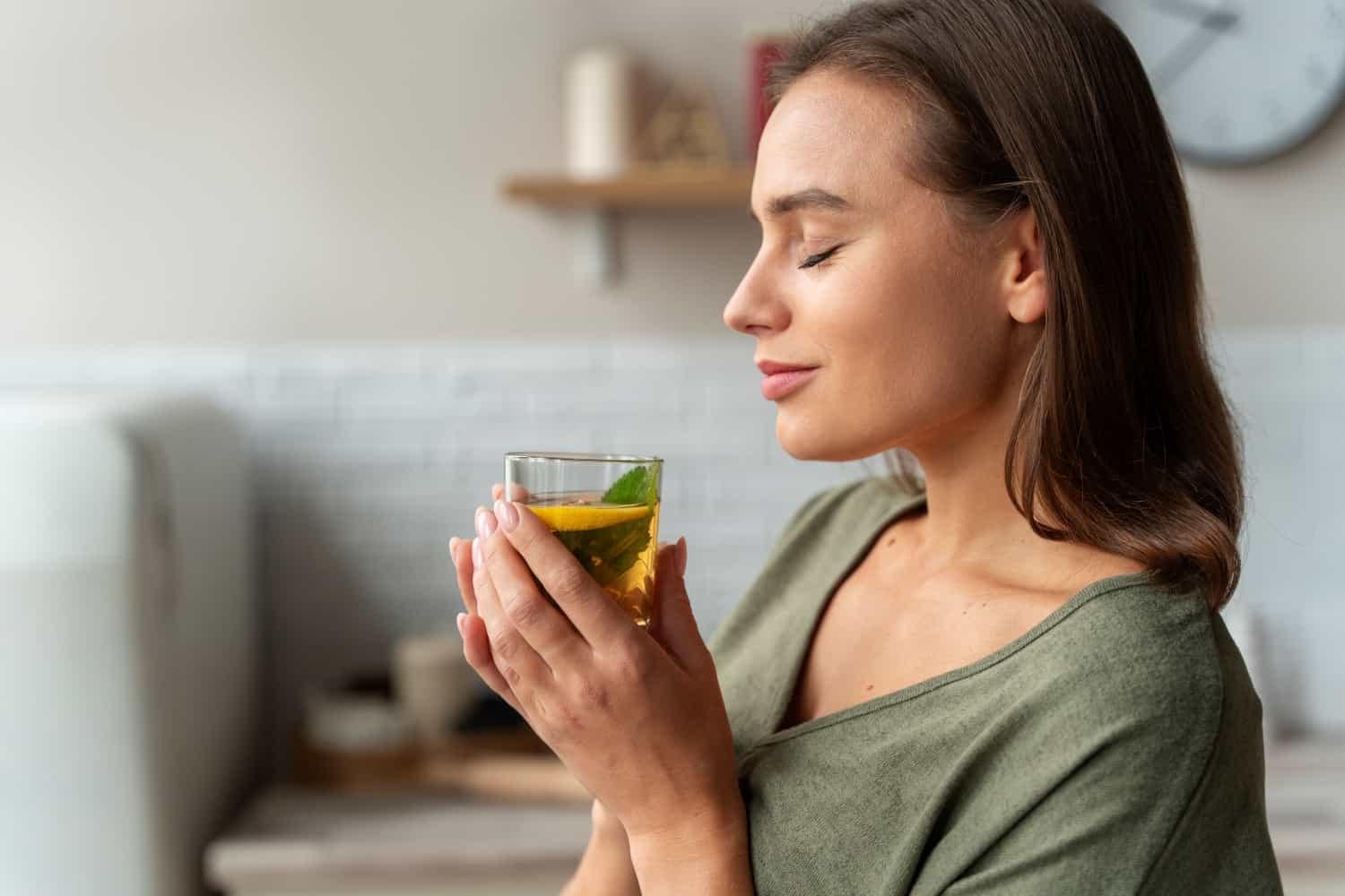 8 opções de chá para gordura no fígado 1 person drinking kombucha home kitchen redimensionada