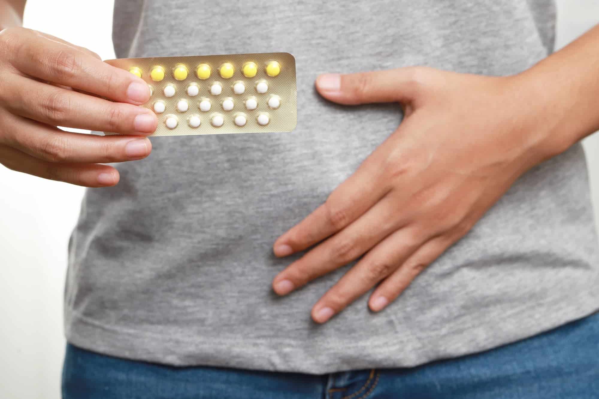 woman taking pills birth control